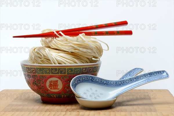 Chinese Yangchun noodles in bowl with chopsticks and porcelain spoon