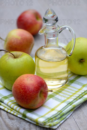 Carafe with apple vinegar and apples