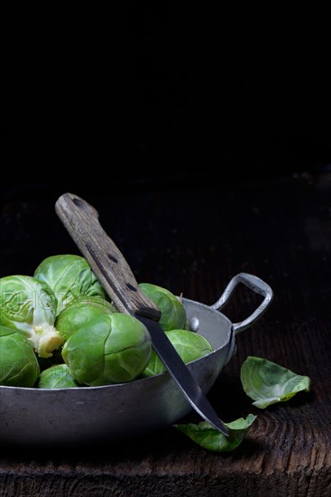 Brussels sprouts in bowl with kitchen knife