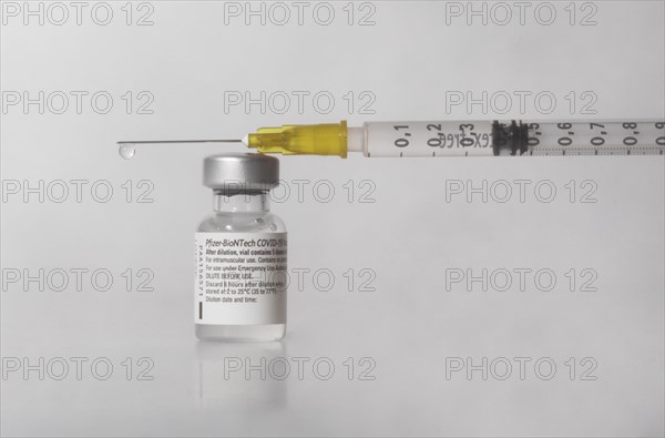 Vaccine vial against Covid 19 and syringe with drops