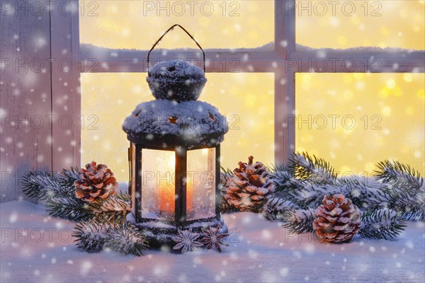 Lantern with Christmas decoration on windowsill