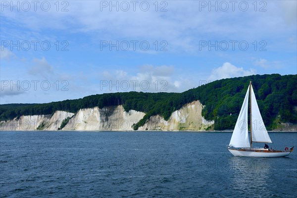 Chalk coast with sailing boat