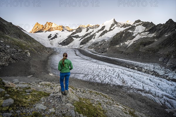 Mountaineer standing in front of glacier