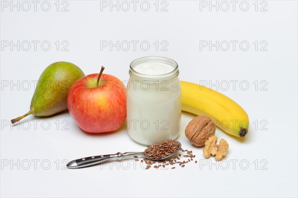 Yoghurt in glass with fruits and linseed