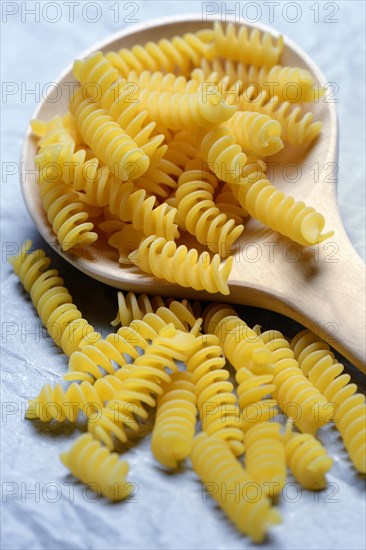 Spiral noodles in wooden ladle