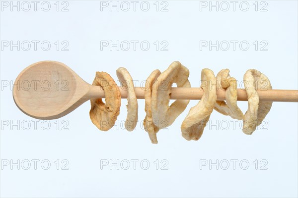 Apple rings on wooden spoon