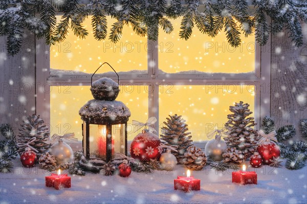 Lantern with Christmas decoration on windowsill