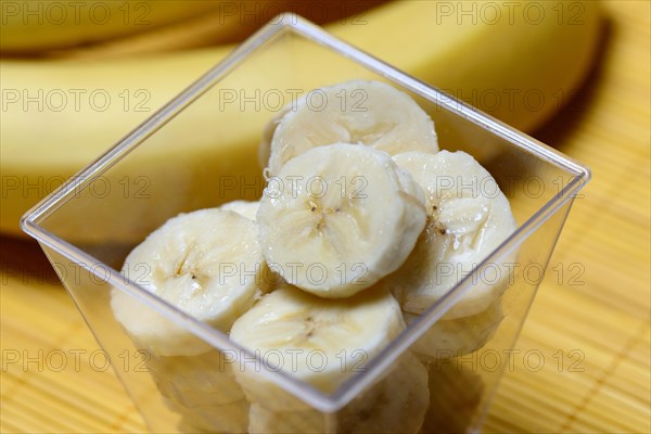 Banana slices in peel and bananas