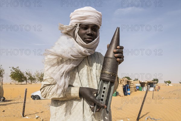 Young Man posing with an old rockethead