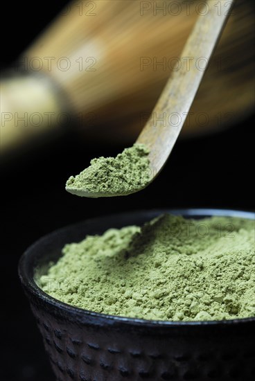 Japanese Matcha tea in bowl with bamboo spoon