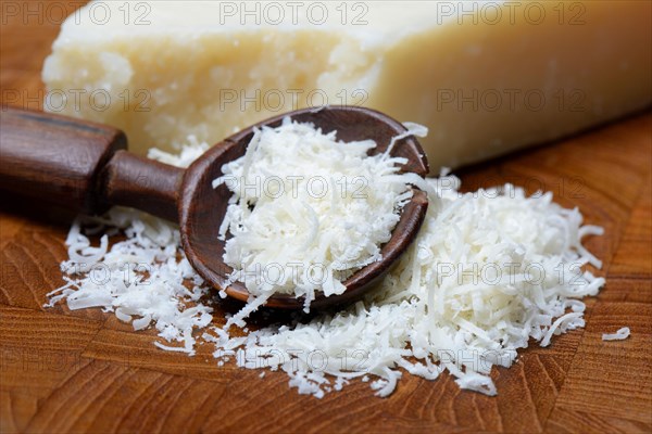 Grated Parmesan cheese and piece of Parmesan cheese