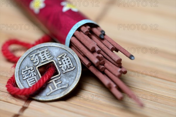 Incense sticks and lucky coin