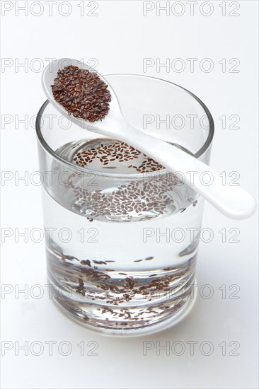 Glass of water and spoon with psyllium