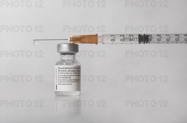 Vaccine vial against Covid 19 and syringe with drops