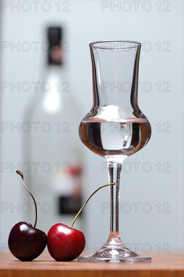 Glass of cherry brandy with cherries