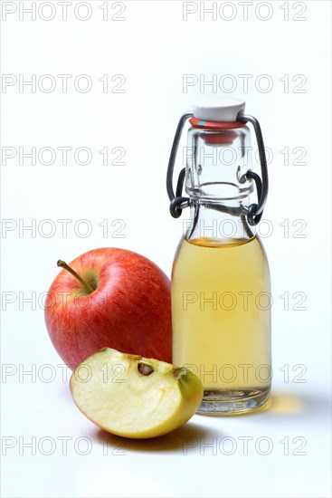 Bottle with apple vinegar and apples