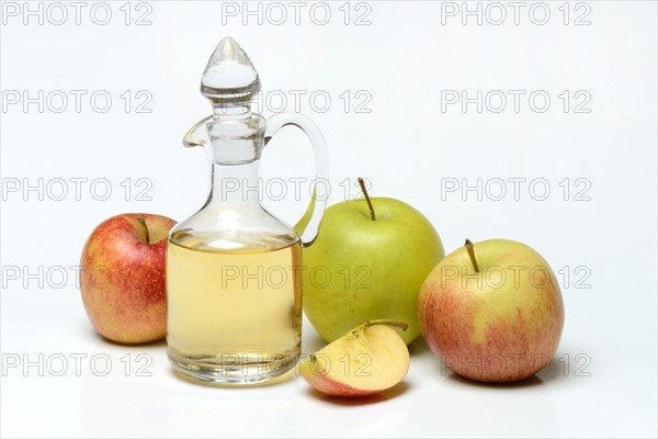 Carafe with apple vinegar and apples