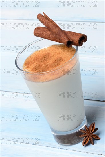 Cinnamon milk in glass with cinnamon sticks and star anise