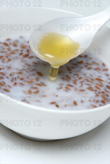 Bowl of swollen flax seed and spoonful of honey