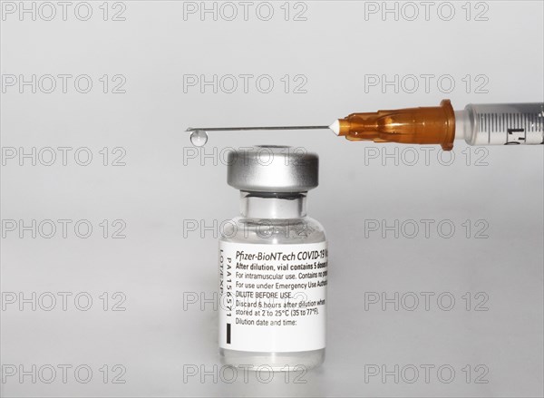 Vaccine vial against Covid 19 and syringe with drops