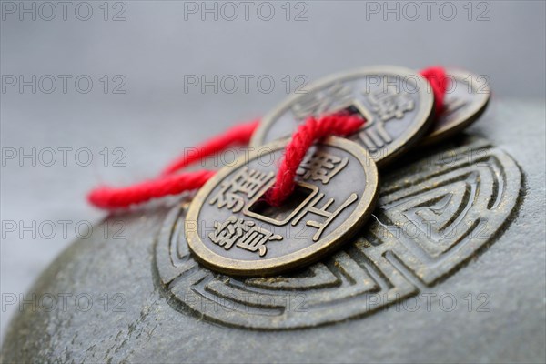 Chinese lucky coins on stone with seal