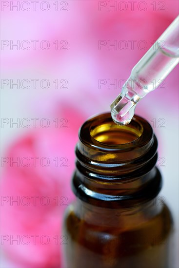 Pipette with drops and brown bottle