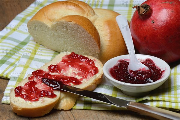 Pomegranate jelly on a slice of butter plait