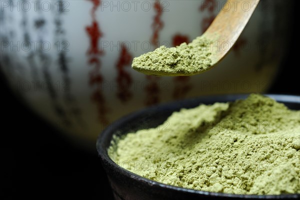 Japanese Matcha tea in bowl with bamboo spoon