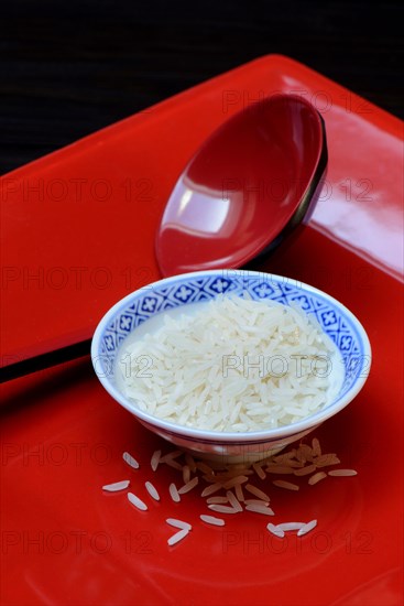 Rice grains in bowls and chopsticks