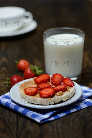 Corn and rice waffle topped with strawberries and peanut butter