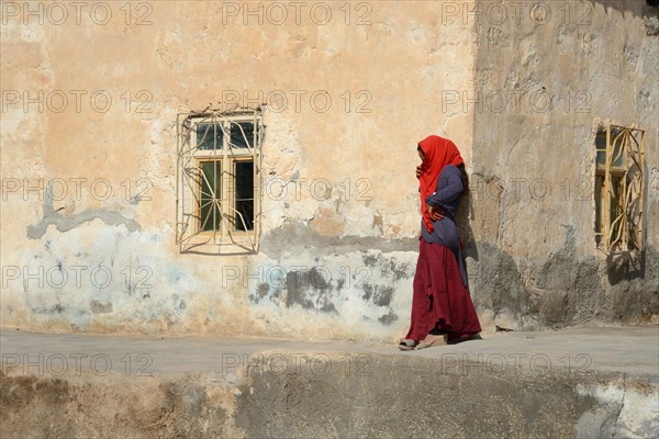 Woman on house wall