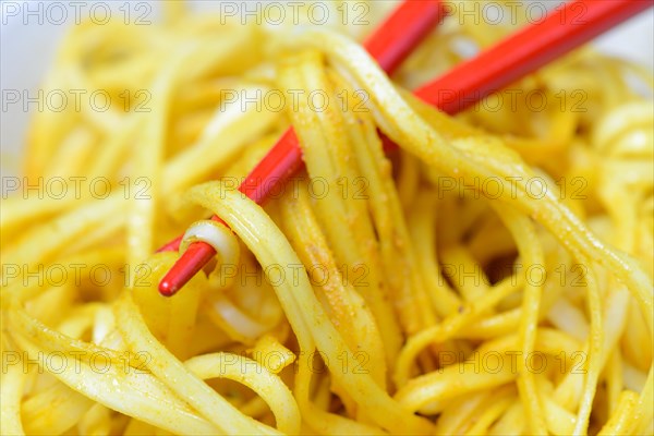 Chinese noodles in bowl with chopsticks