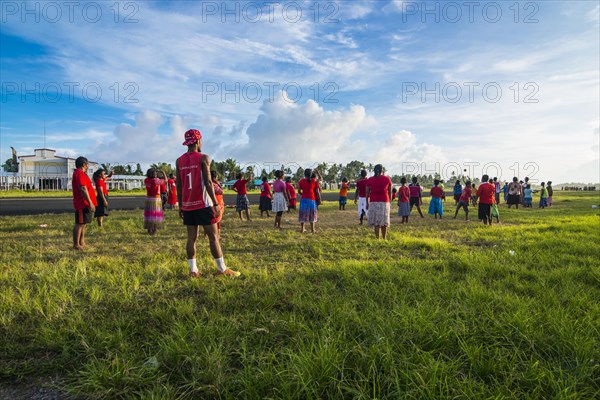 Villagers play volleyball together