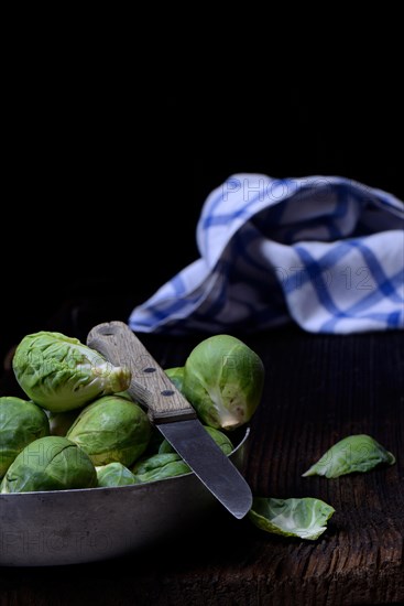 Brussels sprouts in bowl with kitchen knife