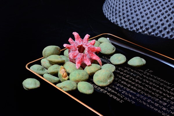 Wasabi peanuts and candied hibiscus flower