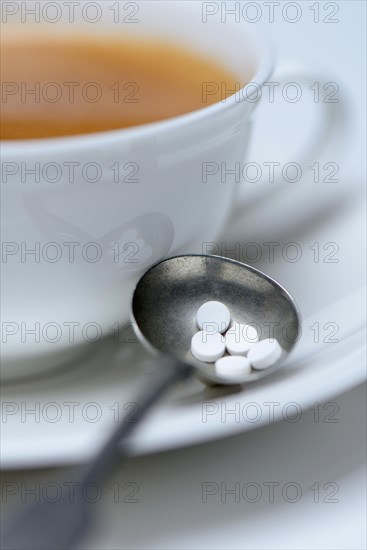Sweetener tablets and coffee cup