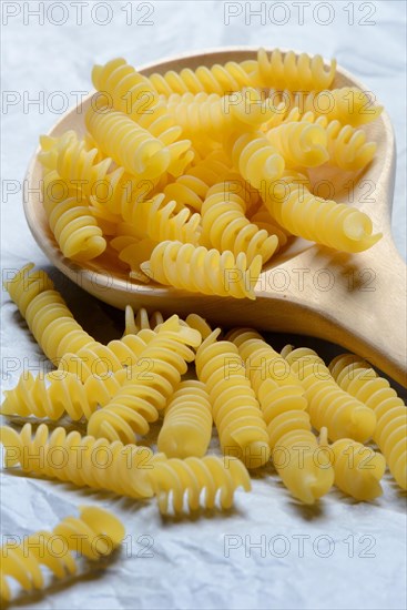 Spiral noodles in wooden ladle