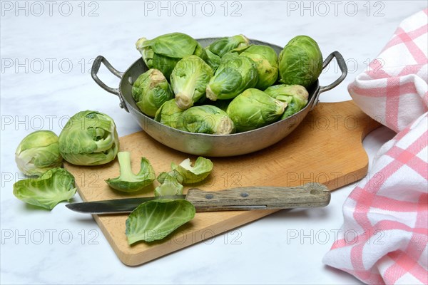 Brussels sprouts in a bowl with kitchen knife