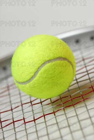 Tennis ball on racket