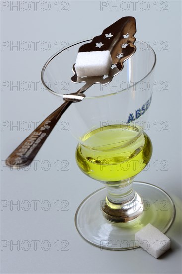 Glass of absinthe with absinthe spoon and sugar cubes