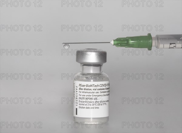 Vaccine vial against Covid 19 and syringe with drops