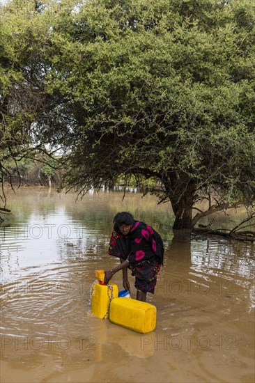 Woman fetches water in canisters