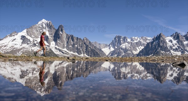 Young woman walking in front of mountain panorama