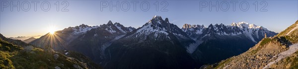 Sun in front of mountains