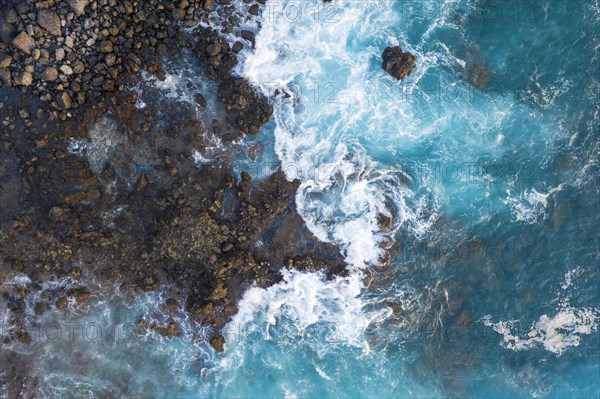 Surf on rocky coast from above
