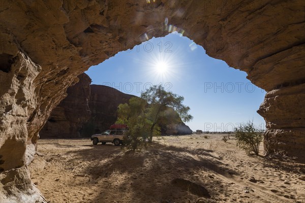 Off-road vehicle under rock arch