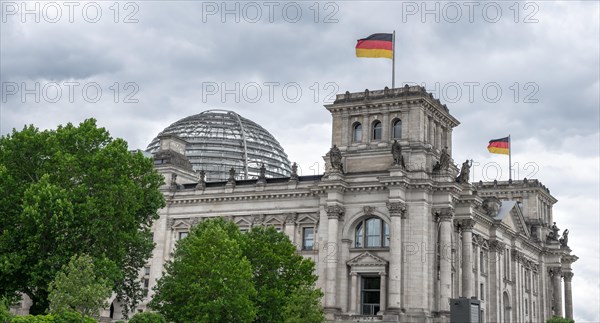 Reichstag building with waving German flag