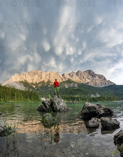 Young man standing on a rock on the shore