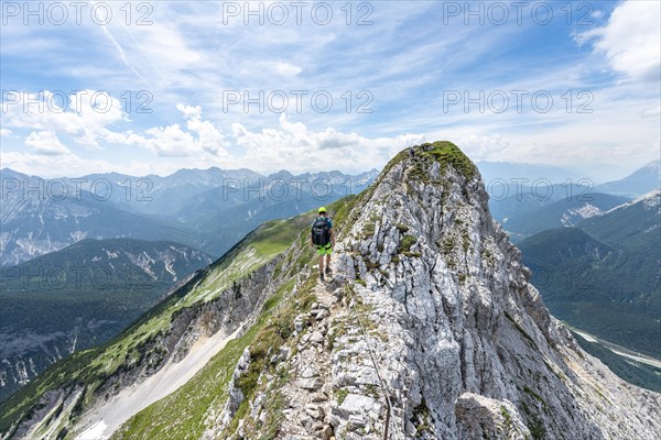 Mountaineer on a ridge on a secured via ferrata