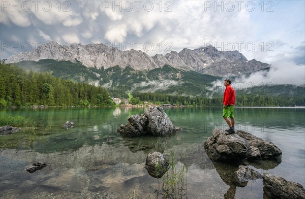 Young man standing on a rock on the shore